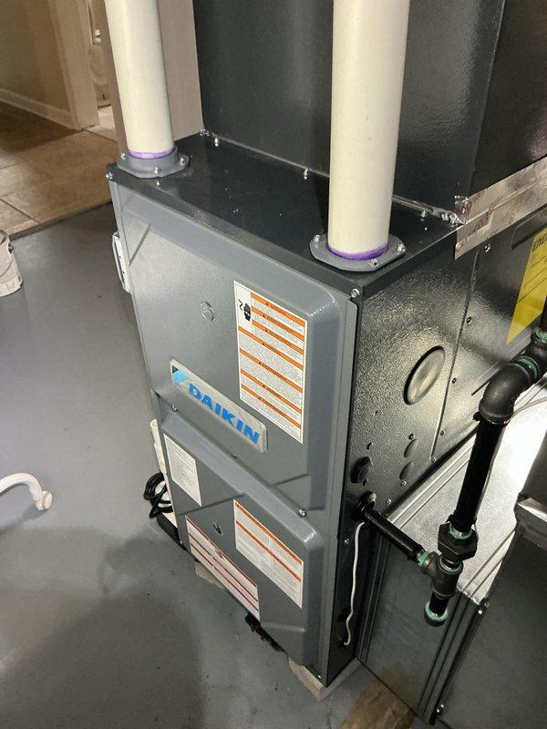 Completed comprehensive tune-up inspection on 4-year-old Daikin furnace system located in basement mechanical room. Performed full system evaluation including thermostat functionality check, humidifier inspection with specific attention to tubing line showing black discoloration from humidifier to ceiling joist, and hot water tank assessment. All safety controls, venting, and operational parameters verified during standard maintenance protocol.