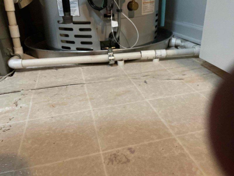 Completed comprehensive HVAC tune-up on a 4-year-old system with air handler located in utility room and outdoor condensing unit. Performed thorough inspection of all system components including thermostat calibration, humidifier operation check, and hot water tank assessment. System found operating within normal parameters with all components functioning properly; documented equipment condition with photos for service records.