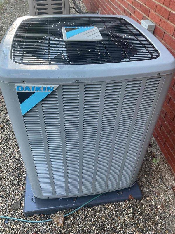 Completed NSP air conditioning inspection on Daikin outdoor condensing unit and associated indoor furnace system. Performed visual assessment of exterior condenser unit, confirming proper placement on concrete pad with adequate clearance, verified manufacturer labeling and unit identification, and documented equipment condition showing no visible signs of damage, excessive wear, or deterioration. Conducted interior inspection of furnace cabinet, examining blower motor assembly, electrical connections, refrigerant line sets, and mounting hardware. All components appeared secure with normal operational wear patterns observed on copper refrigerant lines. System documentation photographed for service records.