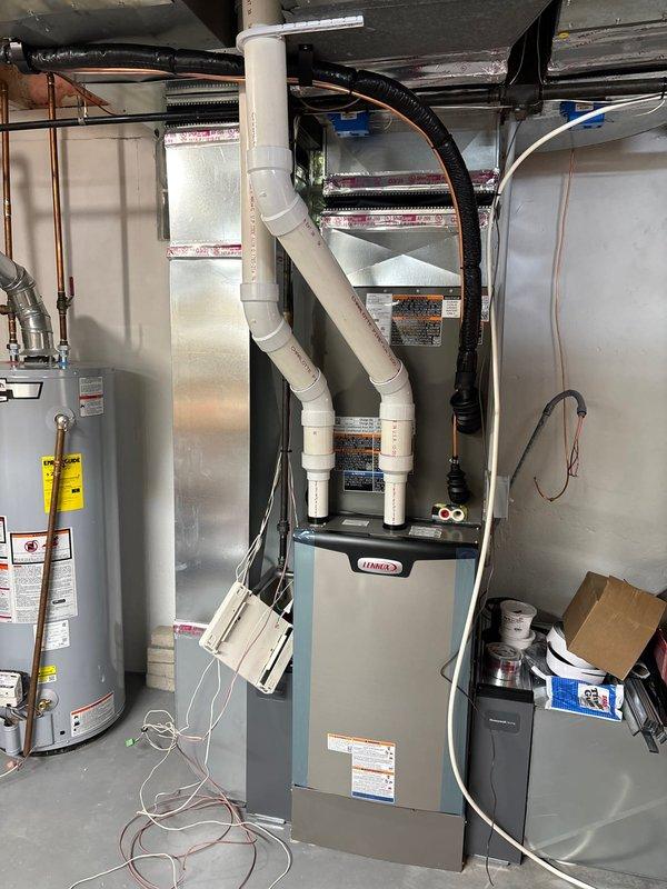 Completed full HVAC system installation including 110,000 BTU Lennox furnace, 4-ton air conditioning unit positioned on right side of property, and complete zone control system with S40 thermostat, 600M zone panel, and circulation pump. Installation included all necessary ductwork modifications, PVC intake and exhaust venting for high-efficiency furnace operation, electrical connections and disconnects, refrigerant lines, condensate drainage, and system integration with existing infrastructure. Obtained mechanical and electrical permits, verified proper airflow and zone damper operation, performed startup procedures, confirmed AHRI certification match (215886497), completed utility rebate documentation for energy-efficient equipment, and ensured all components met manufacturer specifications and local code requirements.