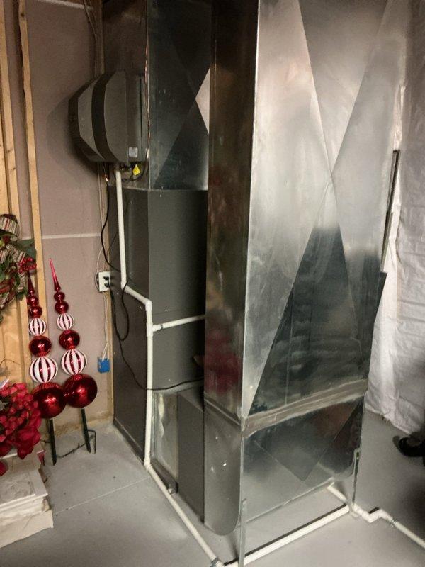 Completed comprehensive air conditioning inspection and tune-up service on residential HVAC system located in basement utility area. System evaluated and found to be operating within normal parameters; all mechanical components, ductwork, and drain lines inspected with no immediate service needs identified.