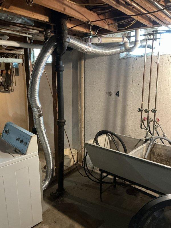 Responded to service call for dryer vent replacement in residential basement utility area. Upon arrival, performed diagnostic assessment of existing ventilation system and identified deteriorated flexible aluminum ductwork requiring replacement. Disconnected old dryer vent ducting from appliance connection point and removed compromised sections. Installed new code-compliant flexible aluminum duct, ensuring proper diameter and secure connections at both the dryer exhaust outlet and exterior termination point. Verified adequate airflow, checked all connections for proper sealing to prevent lint accumulation and moisture infiltration, and confirmed vent routing minimized bends for optimal efficiency. Tested dryer operation to ensure proper ventilation function. Cleared work area and removed all debris from premises.
