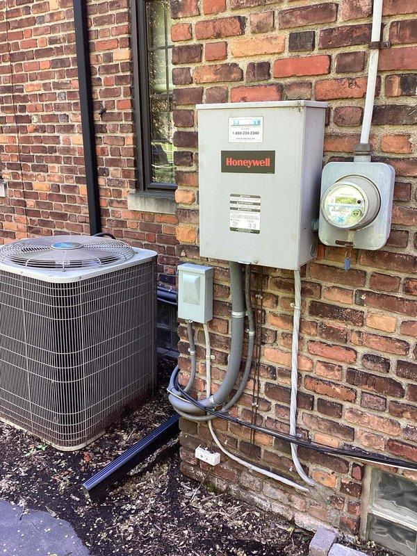 Completed electrical estimate for a 22 KW Honeywell residential standby generator system. Unit is currently operational and located on exterior foundation with proper electrical conduit installation and utility meter connection. Generator is enrolled in maintenance plan program, with equipment assessed for proper installation specifications, electrical panel configuration, and accessibility for future service requirements.