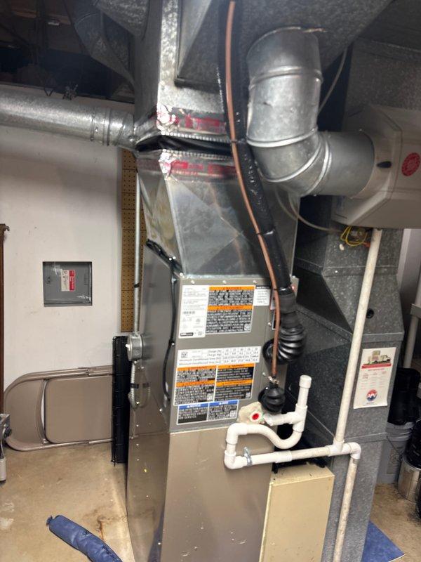 Completed installation of 2-ton air conditioning unit with evaporator coil at rear location. Installed new air handler with integrated coil, connected refrigerant lines, installed condensate drainage system using PVC piping, and performed electrical reconnection. System was evacuated, charged with refrigerant to manufacturer specifications, and tested using digital manifold gauges to verify proper pressures and operation.