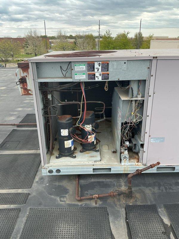 Completed commercial HVAC maintenance agreement service on two rooftop units at commercial facility with operating hours from 12-8. Performed thorough inspection of RTU systems, accessing internal components including dual compressors, refrigerant lines, and electrical controls. Documented existing rust deterioration on exterior panels and general weathering of unit casings, with filters ordered and placed on purchase order for future installation.