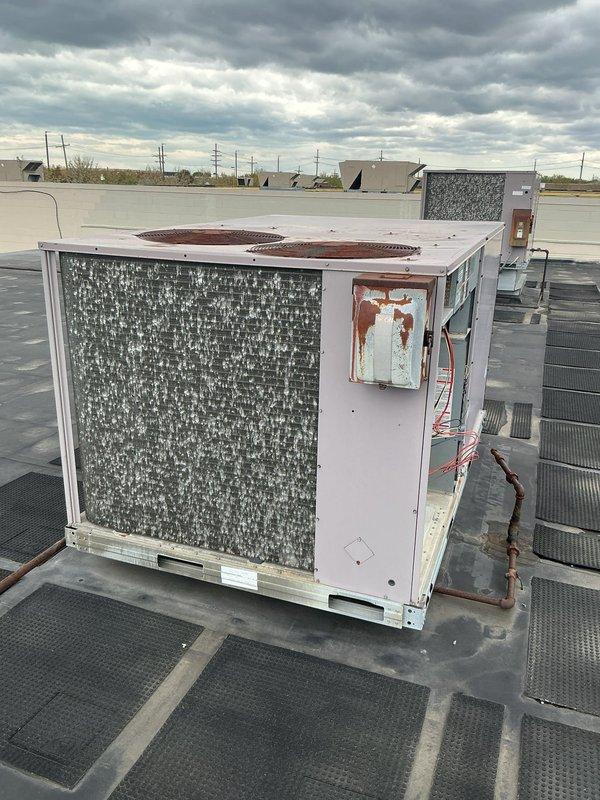 Completed commercial HVAC maintenance agreement service on two rooftop units at commercial facility with operating hours from 12-8. Performed thorough inspection of RTU systems, accessing internal components including dual compressors, refrigerant lines, and electrical controls. Documented existing rust deterioration on exterior panels and general weathering of unit casings, with filters ordered and placed on purchase order for future installation.
