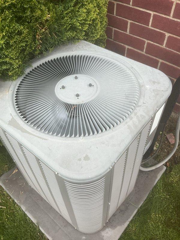 Completed preventive maintenance tune-up on 10+ year old residential air conditioning system with coil located in basement. Performed comprehensive inspection of outdoor condenser unit, verified proper operation of fan motor and compressor, checked refrigerant lines and electrical connections at disconnect box. Unit found in normal operating condition with minor surface weathering; all components functioning within manufacturer specifications.