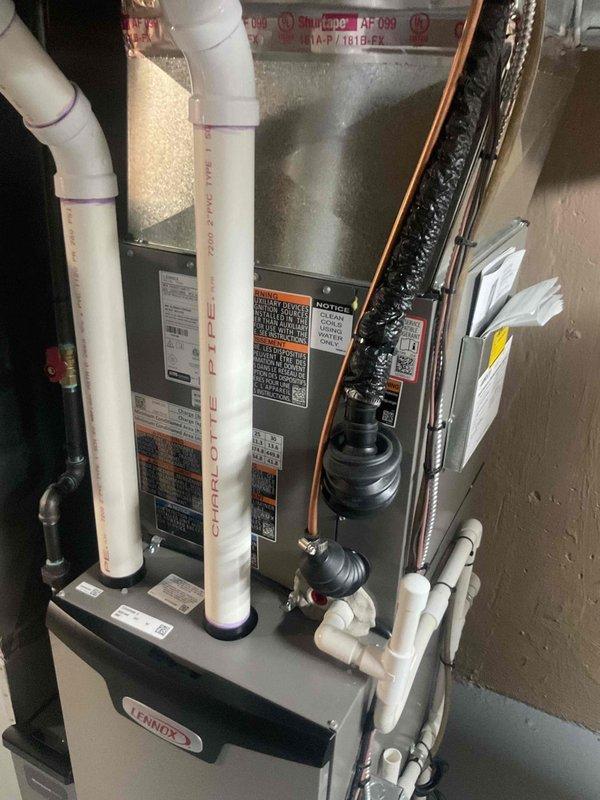 Completed air conditioning system startup and inspection for residential Lennox HVAC installation with basement evaporator coil. Performed operational testing of outdoor condenser unit and indoor air handler, verified proper refrigerant line connections and insulation integrity, confirmed condensate pump operation and drainage system functionality, and inspected all electrical connections including disconnect box. System successfully commissioned with all components operating within manufacturer specifications.
