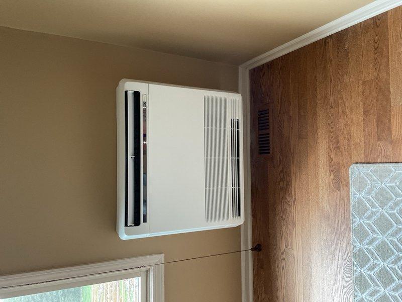 Completed full mini split system installation in residential bedroom, including wall-mounted indoor air handler unit positioned high on interior wall above window for optimal air distribution. Coordinated with licensed electrician for new dedicated circuit installation and subpanel work to support system electrical requirements. Installed outdoor condensing unit, ran refrigerant line set and condensate drain through wall penetration, pressure tested system, evacuated lines, charged with refrigerant per manufacturer specifications, and verified proper operation of all heating and cooling functions.