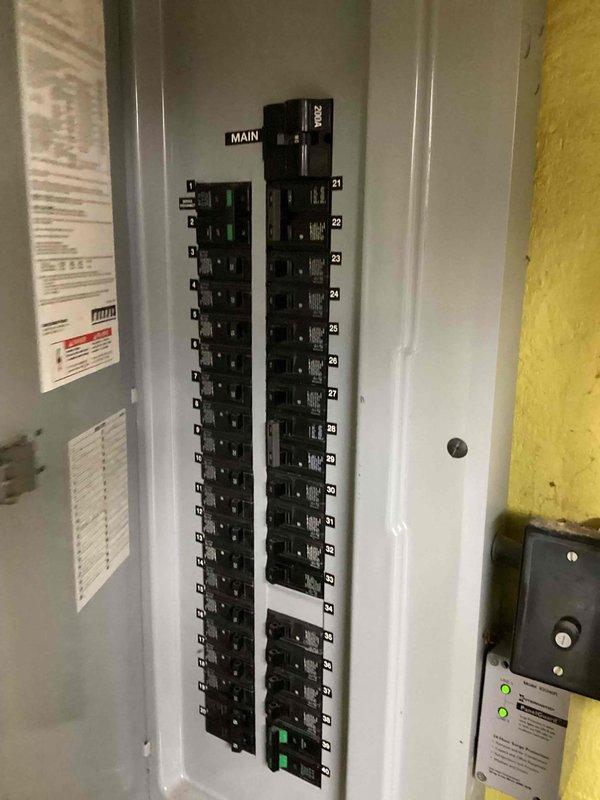 Completed estimate for furnace replacement at residential property. Existing outdoor HVAC condenser unit shows significant weathering, corrosion on fan grille, and debris accumulation, positioned on concrete pad against privacy fence in narrow side yard access area. Assessed electrical panel configuration with 225A main breaker to verify compatibility for new furnace installation. Previous furnace unit was originally installed by another contractor, with current maintenance contract extending through 2026. Documented existing equipment condition and electrical infrastructure via photographs for replacement proposal. Replacement unit will be installed at same side-of-house location as existing furnace.