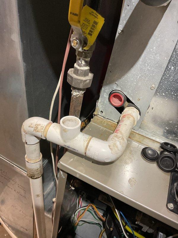 Completed comprehensive A/C system inspection on residential cooling unit. Performed electrical diagnostics using clamp meter, recording amperage draw of 23.75 amps at condenser unit. Inspected indoor mechanical components including gas line connections with shutoff valve, PVC condensate drain system, and electrical wiring connections. Evaluated outdoor condenser unit condition, noting normal operational wear and proper electrical terminal connections. System operating within normal parameters at time of inspection.