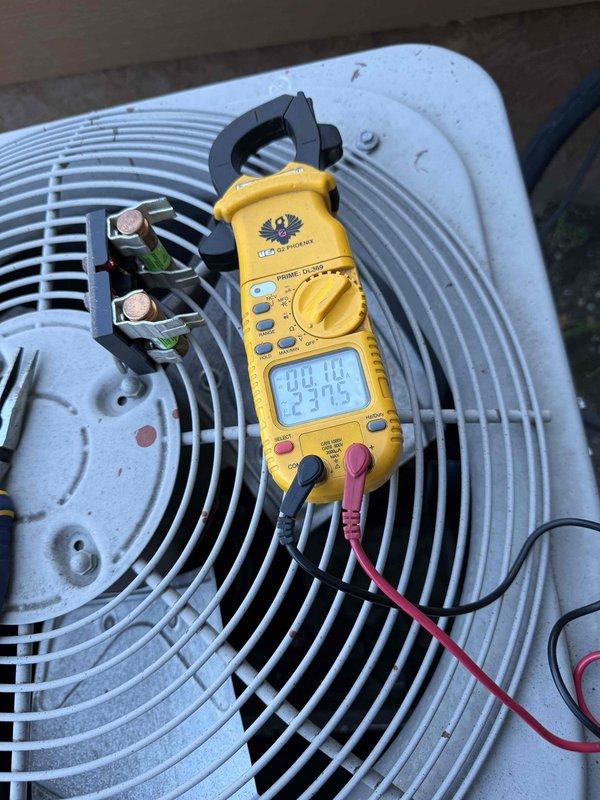 Completed comprehensive A/C system inspection on residential cooling unit. Performed electrical diagnostics using clamp meter, recording amperage draw of 23.75 amps at condenser unit. Inspected indoor mechanical components including gas line connections with shutoff valve, PVC condensate drain system, and electrical wiring connections. Evaluated outdoor condenser unit condition, noting normal operational wear and proper electrical terminal connections. System operating within normal parameters at time of inspection.