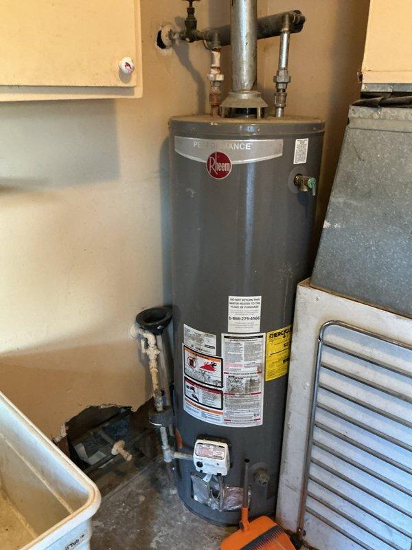 Responded to water leak complaint in utility room. Upon inspection, identified leaking pipes connected to Rheem water heater. Assessed plumbing connections, valves, and supply lines for source of leak. Documented equipment condition and leak location through photo documentation of water heater, surrounding piping infrastructure, and HVAC system in mechanical space. Provided customer with findings and recommended repair options to resolve active leak condition.