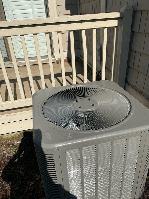 Completed non-service plan air conditioning inspection on Lennox model ML13KC1-042-230A02 condenser unit located at exterior of property. Unit manufactured in March 2025 utilizes R-454B refrigerant and operates on 208/230V single-phase power. Performed visual inspection of outdoor condenser, confirming unit is properly positioned on ground surface adjacent to deck structure with adequate clearance for airflow. Verified condenser coil condition, fan grille assembly, and external cabinet integrity showing no visible damage, excessive wear, or debris accumulation. Checked manufacturer data plate for proper identification and specifications. Unit appears to be operating within normal parameters with no immediate service concerns identified at time of inspection. Documented equipment condition with photographs for service records.