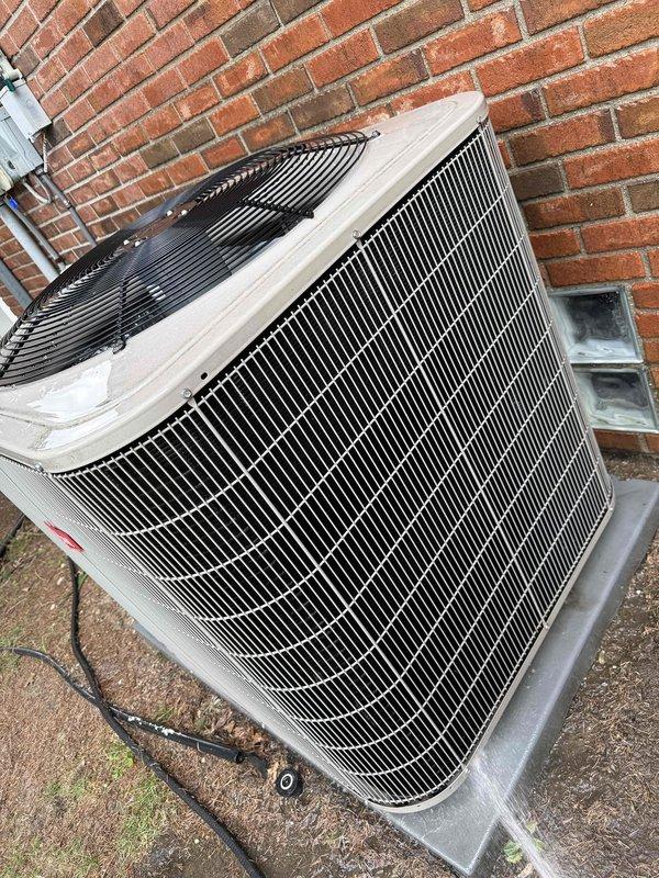 Completed comprehensive Gold AC inspection on multi-unit residential HVAC system with 10-year-old equipment, including two outdoor condenser units and basement-located air handler. Performed electrical diagnostics using clamp meter to verify proper amperage draw and voltage readings on both condensers, inspected condenser coils through protective grilles, evaluated unit housings for wear and weathering, and confirmed both systems operational. All equipment functioning within normal parameters at time of inspection.