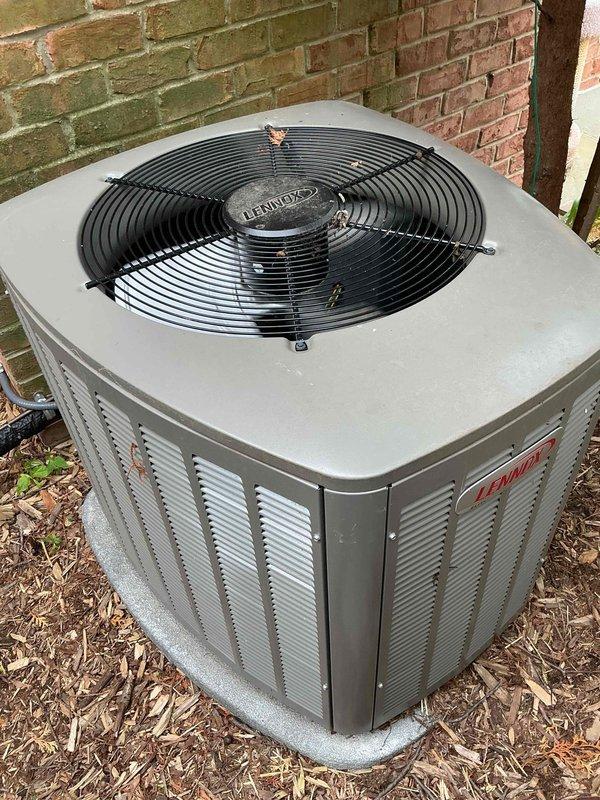 Completed comprehensive Gold AC inspection on residential property with three Lennox condenser units over 10 years old and air handler located in basement. Performed thorough visual inspection of outdoor equipment, verified operational status of all systems, checked refrigerant line connections and electrical conduit mounting, and documented equipment condition with photos showing units in functional condition with minor surface wear on cabinets and fan assemblies intact.