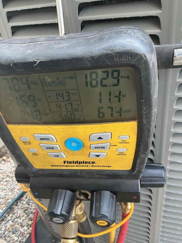 Performed AC startup and system commissioning on basement evaporator coil installation. Utilized refrigerant manifold gauge set to verify proper system pressures, recording 182.9 psig on high side with additional temperature and superheat measurements to ensure optimal refrigerant charge and system performance. System tested and confirmed operational within manufacturer specifications.