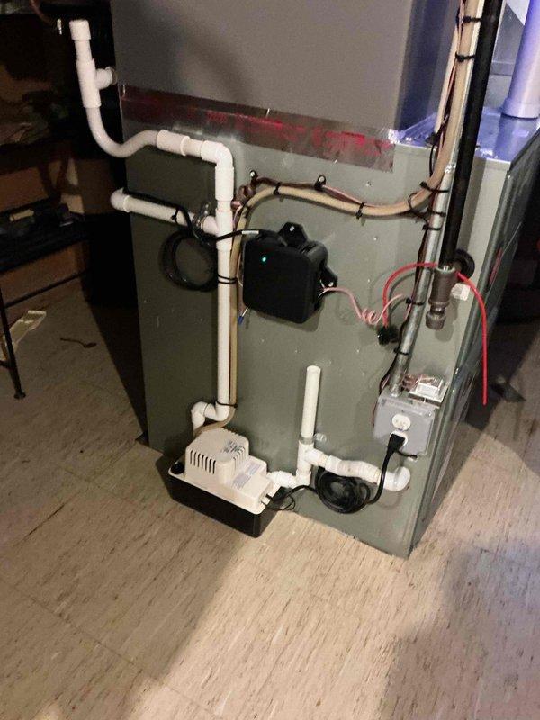 Completed full HVAC system installation including new air conditioning unit and evaporator coil. Installed condensate pump with white PVC drain lines and proper drain pan for moisture management. Ran and secured refrigerant lines with appropriate insulation and mounting hardware. Connected electrical wiring and power supply to all components. Verified all connections, tested system operation, and confirmed proper drainage from condensate pump. Installation included APCO air purification system integration. Permit was requested for the installation work. System checked and confirmed operational upon completion.