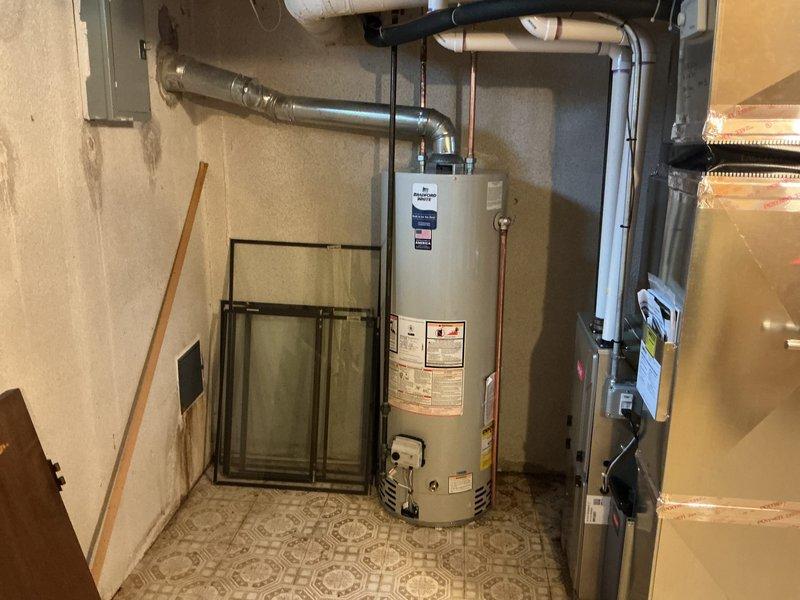 Installed a 40-gallon standard capacity tanked water heater in basement utility area, including all necessary copper supply line connections, pressure relief valve, and electrical hookup. Unit was properly positioned, leveled, and integrated with existing plumbing infrastructure, with all connections tested and verified operational upon completion.