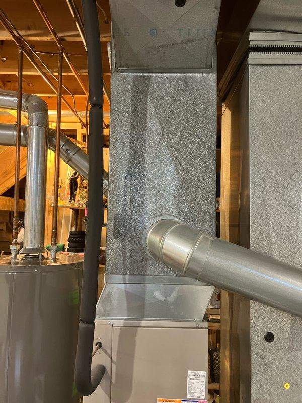 Performed comprehensive diagnostic evaluation on non-operational 14-year-old Bryant furnace system located in basement. Identified multiple critical component failures including oil-leaking blower motor, seized inducer motor causing grinding and squeaking noises, and cracked heat exchanger. Documented existing HVAC installation with vertical ductwork system and provided furnace replacement estimate to address safety concerns and restore heating functionality.