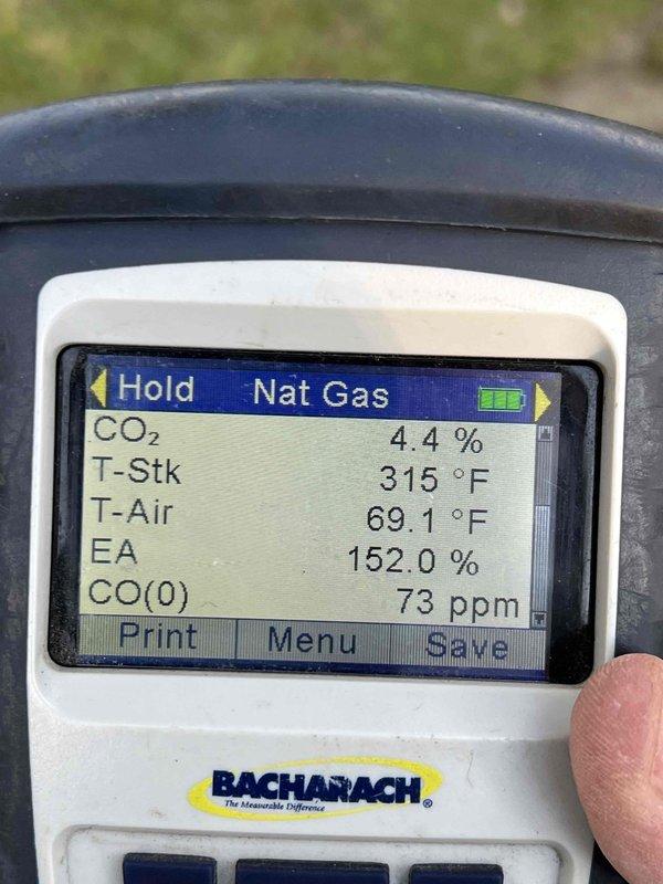 Completed tune-up maintenance on two 8-year-old furnaces located in kitchen area. Performed combustion analysis on natural gas furnace using digital analyzer, recording CO₂ levels at 4.4%, stack temperature at 315°F, ambient air temperature at 69.1°F, excess air at 152.0%, and carbon monoxide at 73 ppm. Inspected furnace components, ductwork connections, and PVC venting system. All equipment operational at time of service.