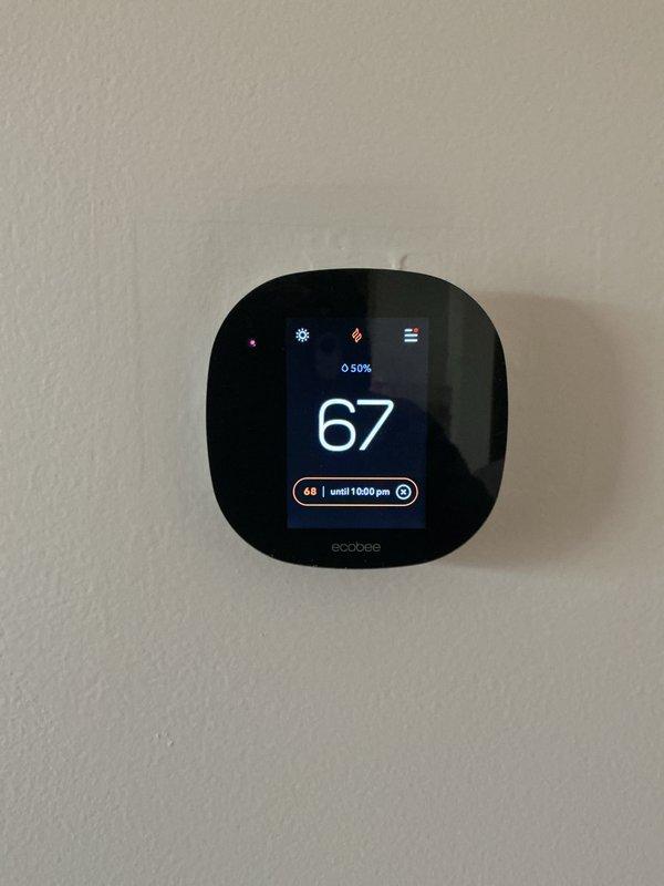Completed comprehensive Gold AC inspection on 15-year-old Lennox HVAC system with air handler located in basement. Performed thorough evaluation of furnace unit, examined PVC intake and exhaust venting, inspected refrigerant lines and condensate drain system, and assessed Ecobee smart thermostat functionality set to 67 degrees. System evaluated for performance and maintenance needs, with equipment photographed for service records.