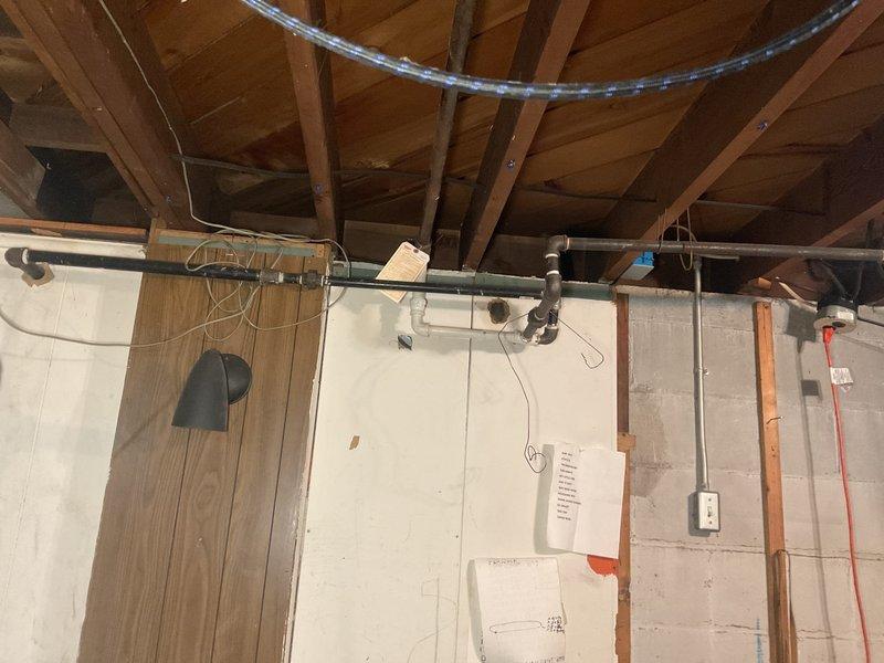 Responded to service call for gas line evaluation in residential basement where four gas leaks had been previously identified. Performed comprehensive visual inspection of gas piping system throughout unfinished basement area, including exposed gas lines running along concrete block walls and connections near water heater and HVAC equipment. Conducted pressure test on gas distribution system to verify leak locations and assess overall system integrity. Documented existing gas line configuration, including black iron pipe routing, fittings, and connection points to appliances. Evaluated condition of gas piping infrastructure, noting age, installation methods, and accessibility for potential repair work. Photographed gas line installation and mechanical room layout for estimation purposes. Identified compromised sections of gas piping requiring attention to restore system to safe operating condition. Provided homeowner with detailed assessment of gas line system and discussed options for