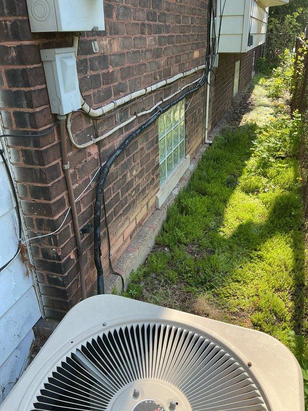 Conducted estimate for complete HVAC system replacement at residential property with 26-year-old R22 air conditioning system that is non-operational due to low refrigerant and age-related failure. Assessed existing outdoor condensing unit positioned on concrete pad in narrow side yard passageway, documented current system configuration including utility connections and electrical service, and provided comprehensive quote for new high-efficiency AC system installation to replace obsolete R22 equipment.