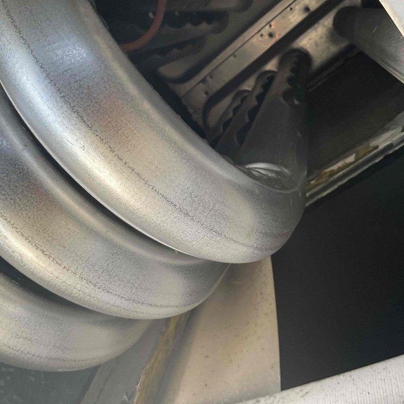 Performed preventive maintenance inspection on two rooftop units as part of commercial HVAC maintenance agreement. Accessed equipment using ladder, conducted thorough examination of ductwork connections, flexible duct components, and associated mechanical systems. Documented equipment condition with photographs showing ductwork integrity, insulation status, and overall system operation; all components found in normal working condition with typical wear patterns.