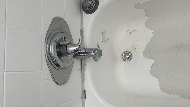Completed conversion of bathtub drain assembly from trip lever style to lift-and-turn type mechanism. Replaced existing half bath faucet with new fixture, including installation of brushed metal cross-handle faucet assembly on bathroom sink. Inspected existing shower/tub area, noting significant deterioration of fiberglass surface coating with extensive peeling and exposure of underlayer material. Verified proper operation of all new components and confirmed drainage function on both fixtures.
