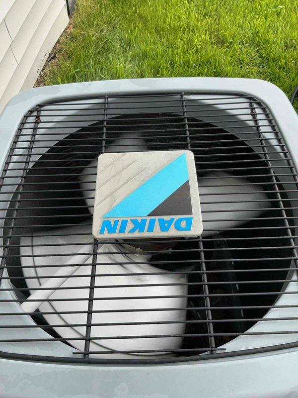 Completed prepaid maintenance inspection on 2018 Daikin air conditioning system with basement evaporator coil. Performed visual inspection of outdoor condenser unit, verified proper fan operation, and documented equipment condition with photos showing unit in good working order with clean exterior housing and unobstructed airflow through protective grille.