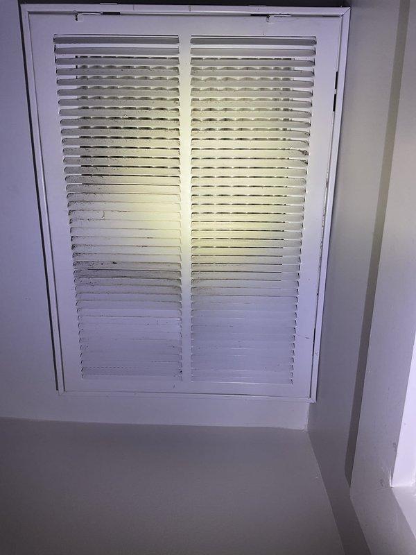 Completed preventative maintenance tune-up on residential furnace unit located adjacent to kitchen area. Inspected and cleaned flame sensor rod, which showed signs of carbon buildup that could affect ignition reliability. Verified proper airflow through return air grille and checked system operation. Advised homeowner of need for carbon monoxide detector installation for safety compliance.