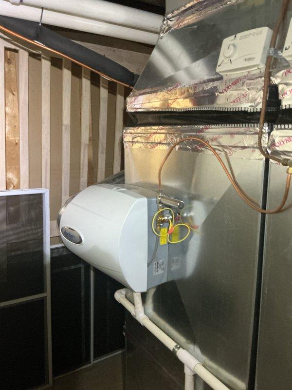 Completed comprehensive Gold AC inspection on 2020 air handler system located in basement. Verified proper operation of cooling system, inspected refrigerant lines, ductwork connections, and electrical components. Confirmed thermostat functionality, checked humidifier integration, and documented all equipment conditions with system operating normally at time of inspection.