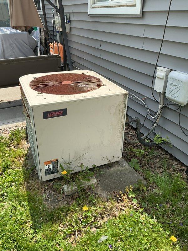 Completed comprehensive estimate for full HVAC system replacement at residential property. Assessed existing equipment including two aging outdoor condensing units (both Lennox brand, 10+ years old), furnace, and water heater, all identified for replacement due to age and customer request. Documented current system conditions through detailed site photography, noting weathering, discoloration, and general wear on exterior units positioned on concrete pads with electrical disconnects and conduit properly installed on gray vinyl siding. Provided quote for complete system upgrade to ensure efficient heating and cooling performance.