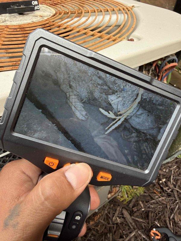 Performed comprehensive AC tune-up on 20-year-old outdoor condenser unit. Conducted visual inspection of exterior components noting significant rust and corrosion on fan guard, utilized borescope camera to inspect internal ductwork and refrigerant lines, verified system operational status. Unit showed age-related wear but maintained functionality with no immediate issues requiring repair at time of service.
