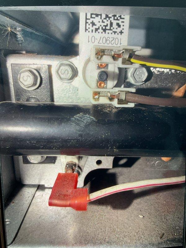 Responded to callback for 2-year-old furnace located in basement with no heat and flashing red light on lower sight glass. Upon arrival, confirmed no power reading on red wire at thermostat and furnace not producing heat. Inspected control board and wiring connections at terminal block, identified loose or failed connection on R terminal causing loss of 24V power to thermostat circuit. Secured all wire connections at terminal block, verified proper voltage present at all thermostat terminals, and tested furnace operation through complete heating cycle. Unit fired normally with all safety controls functioning properly and red indicator light operating as designed.