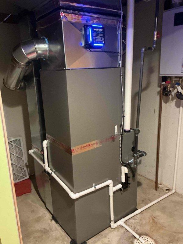 Completed full HVAC system installation including a 70,000 BTU furnace and 2-ton rear-discharge air conditioning unit. Installed Ecobee 3 Lite smart thermostat, reconnected existing humidifier to new system, and ran copper refrigerant lines with proper insulation. Installed PVC condensate drain lines with appropriate fittings and secured all ductwork connections. Mounted outdoor condenser unit on concrete pad adjacent to residence with proper clearances. Obtained mechanical and electrical permits prior to installation. System registered under AHRI certificate 215663276 and qualifies for applicable utility rebates. All equipment tested and operational upon completion.
