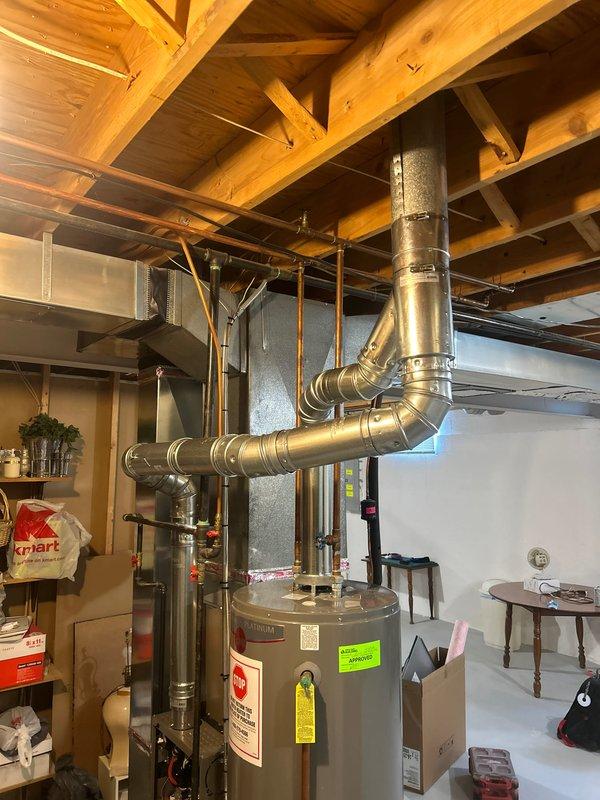Completed mechanical-only installation of a 90,000 BTU high-efficiency furnace with integrated humidifier system in basement utility area. Connected new unit to existing electrical circuit at breaker panel, verified proper 120V power supply and circuit protection for HVAC equipment. Installed new thermostat, reconnected existing ductwork to furnace plenum, and performed final measurements to ensure proper system configuration and code compliance.