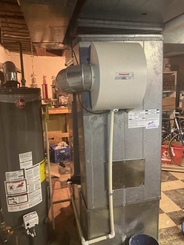 Completed comprehensive Gold AC Inspection on 7-year-old air conditioning system and furnace located in basement. Performed full system diagnostics, cleaned condenser coils, checked refrigerant levels, tested electrical connections, verified thermostat operation, and inspected ductwork for proper airflow. Assessed existing Honeywell humidifier mounted on furnace and provided recommendations for replacement unit due to age and performance concerns. Replaced furnace filters and reviewed maintenance schedule with property owner to ensure optimal system efficiency and indoor air quality throughout the cooling season.