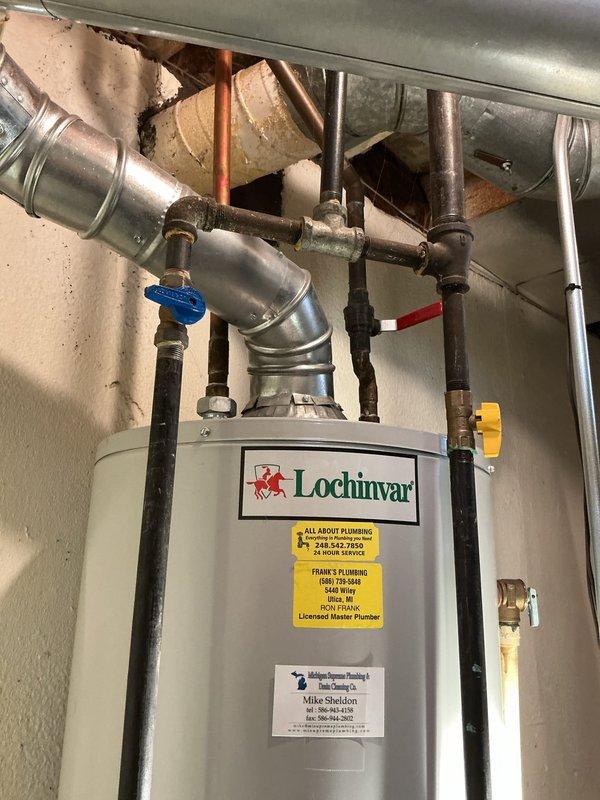 Responded to service call for reported leak on 40-gallon water heater. Upon arrival, performed diagnostic inspection of existing Lochinvar tanked water heater unit installed in utility space. Examined all plumbing connections, including copper supply lines, gas connections via black flexible pipes, and associated shutoff valves. Inspected condition of tank, pressure relief valve, drain valve, and all visible piping connections for signs of active leakage or corrosion. Assessed overall system configuration including blue-handled water shutoff valve, yellow gas valve, and PVC venting arrangement. Documented current installation with photographic evidence showing complete plumbing assembly, HVAC integration, and mechanical room layout. Provided homeowner with findings and discussed replacement options for the water heating system.
