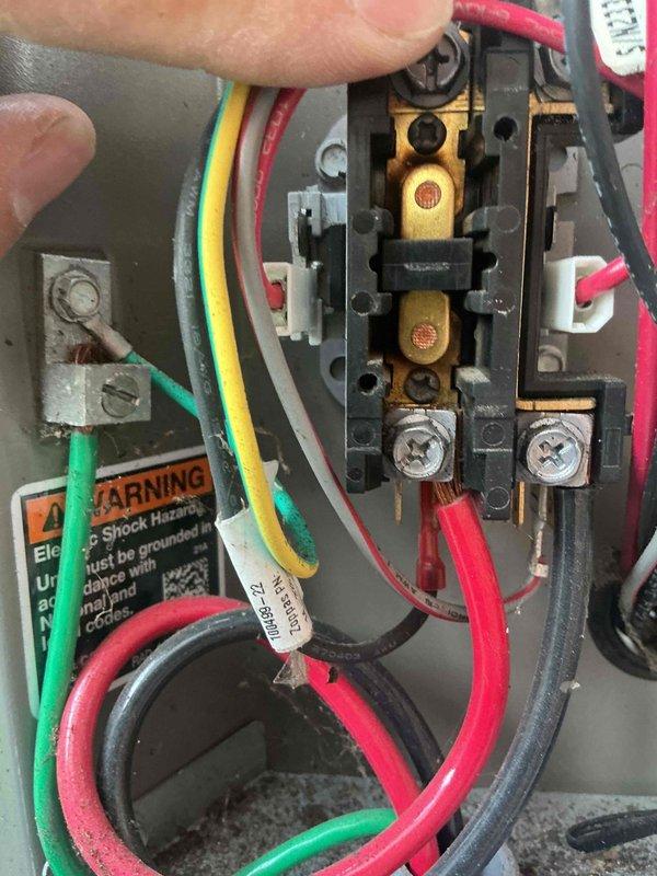 Completed air conditioning inspection and tune-up on one-year-old residential system. Inspected outdoor condenser unit, confirming fan operation, blade integrity, and proper airflow through coil louvers; unit mounted on concrete pad showing normal condition with no visible damage or corrosion. Examined electrical connections at disconnect box, verifying wire terminations, terminal integrity, and proper conductor routing. Air handler located in basement confirmed operational. System operating within normal parameters at time of inspection.
