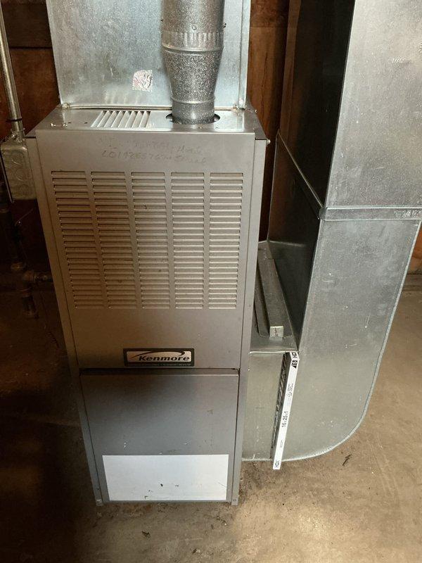 Conducted furnace replacement estimate for a 24-year-old Kenmore unit located in basement as part of city certification for rental property. Inspection revealed two significant cracks in the middle heat exchanger cell, requiring immediate attention due to safety concerns. Comprehensive evaluation included assessment of existing ductwork system, humidifier, thermostat, and hot water tank to provide complete replacement recommendations.