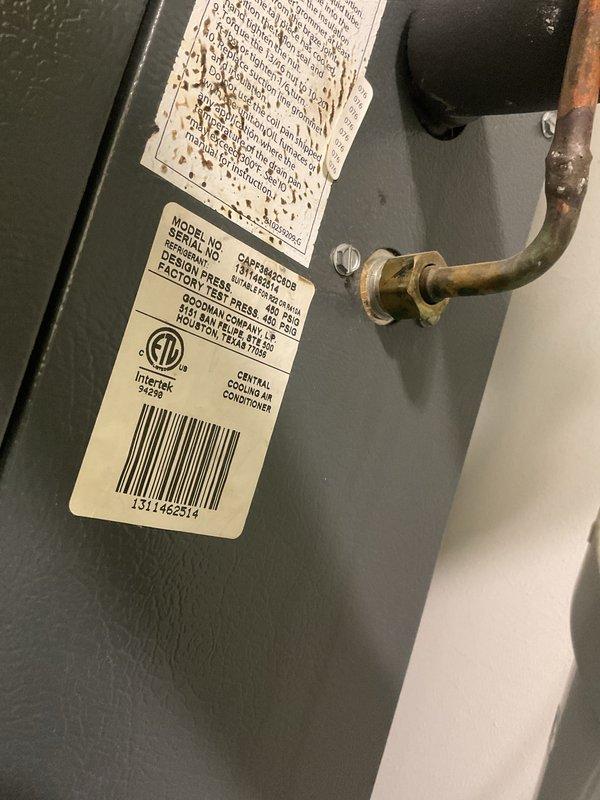 Completed Gold AC Inspection on a 12-year-old Amana central outdoor air conditioning unit located in the basement. Performed comprehensive system evaluation including visual inspection of condenser unit, refrigerant lines, electrical connections, and manufacturer specifications verification. Unit is operational with visible age-related wear on copper piping showing patina and minor label deterioration, but overall system condition remains serviceable for continued use.
