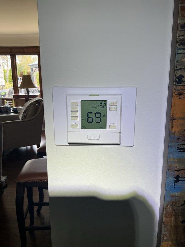 Returned to property to perform leak search and level condenser unit as previously documented. Completed comprehensive Gold AC inspection on multi-unit system consisting of three HVAC systems with two air handlers located in basement and one with refrigerant lines in attic. All equipment is under 10 years old and operational at time of inspection. Verified thermostat functionality showing proper temperature control at 69°F. Conducted thorough system evaluation including refrigerant leak detection, condenser leveling, and performance verification across all three units. All systems functioning properly with no immediate issues identified.