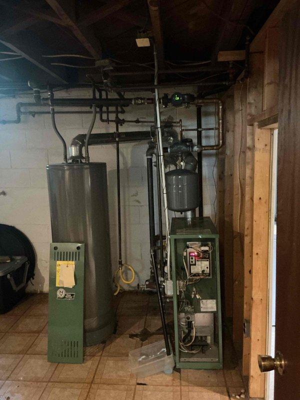 Responded to service call for boiler system experiencing water leak from valve following system drain and refill. Upon inspection, identified leaking valve in the heating system's piping assembly. Performed diagnostic evaluation of the boiler unit and associated hydronic components, including expansion tank and water supply connections. Addressed the valve leak issue, verified system pressure, checked all connections for proper sealing, and confirmed system restored to operational heating capacity with no active leaks present at time of service completion.
