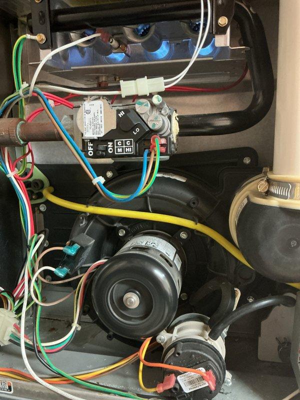 Completed comprehensive tune-up on residential forced-air furnace (September 2016) and air conditioning system located in basement. Performed full system inspection including visual examination of furnace internal components, blower motor assembly, electrical connections, and control board. Verified proper operation of all safety controls and sequencing. Inspected outdoor condensing unit mounted on concrete pad adjacent to building, noting satisfactory condition of unit housing, protective grilles, and refrigerant line set routing. Checked electrical disconnect box and copper line connections at exterior wall penetration. Customer reported humidifier experiencing operational issues; noted for further evaluation. Both heating and cooling systems confirmed operational at time of service, with equipment showing normal wear consistent with age of installation.