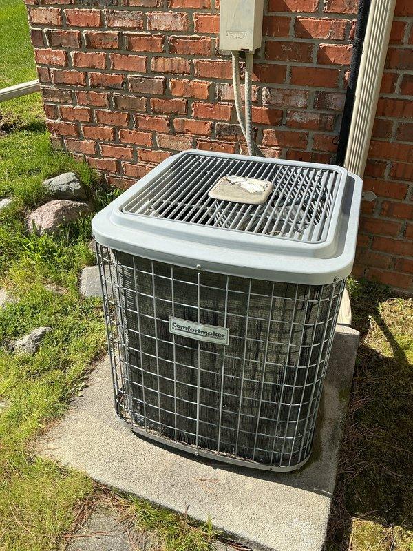 Completed comprehensive tune-up on residential forced-air furnace (September 2016) and air conditioning system located in basement. Performed full system inspection including visual examination of furnace internal components, blower motor assembly, electrical connections, and control board. Verified proper operation of all safety controls and sequencing. Inspected outdoor condensing unit mounted on concrete pad adjacent to building, noting satisfactory condition of unit housing, protective grilles, and refrigerant line set routing. Checked electrical disconnect box and copper line connections at exterior wall penetration. Customer reported humidifier experiencing operational issues; noted for further evaluation. Both heating and cooling systems confirmed operational at time of service, with equipment showing normal wear consistent with age of installation.