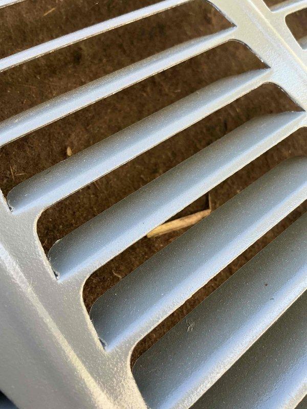 Completed comprehensive Gold AC inspection on one-year-old system with air handler located in basement. Performed full system evaluation including condenser unit examination, evaporator coil assessment, and air filter inspection. Inspected heat exchanger fins and condenser coil assembly, noting minor discoloration on aluminum fins and some oxidation on corrugated components typical of normal operation. Examined ventilation grate and filter medium, observing light dust accumulation and minor debris between slats consistent with regular use. Verified system operational status and documented equipment condition through photographic documentation. Advised customer on importance of maintaining clear area around condenser unit, free from debris and animal waste to ensure optimal system performance and longevity.