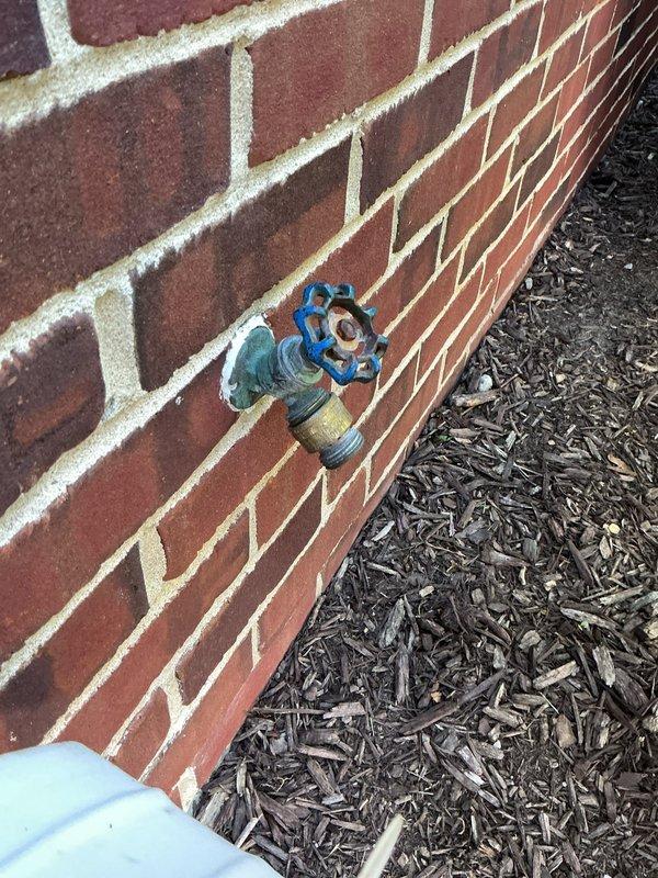 Responded to service call for multiple leaking faucets throughout the property. Addressed dripping outdoor hose bib mounted on exterior brick wall by inspecting valve mechanism and brass fixture components. Performed interior faucet repair by disassembling cartridge assembly, revealing worn stem with visible deterioration requiring replacement. Removed and replaced defective cartridge, seals, and gaskets to restore proper function and eliminate leaks. Provided sink drain plugs as requested to complete service needs.