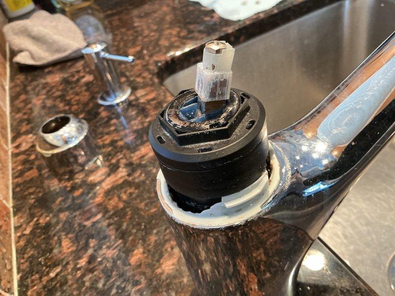 Responded to service call for multiple leaking faucets throughout the property. Addressed dripping outdoor hose bib mounted on exterior brick wall by inspecting valve mechanism and brass fixture components. Performed interior faucet repair by disassembling cartridge assembly, revealing worn stem with visible deterioration requiring replacement. Removed and replaced defective cartridge, seals, and gaskets to restore proper function and eliminate leaks. Provided sink drain plugs as requested to complete service needs.
